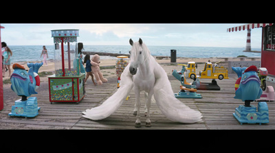 a white horse standing on top of a wooden floor