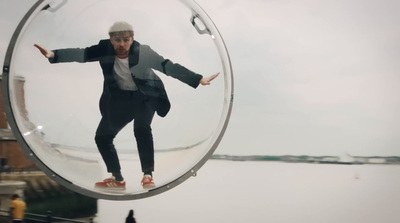 a man in a suit is reflected in a mirror