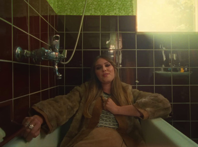 a woman sitting in a bathtub in a bathroom