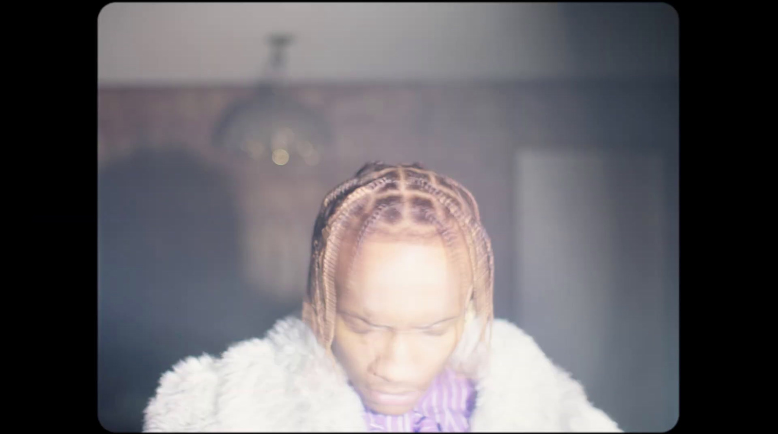 a woman with braids and a purple bow tie