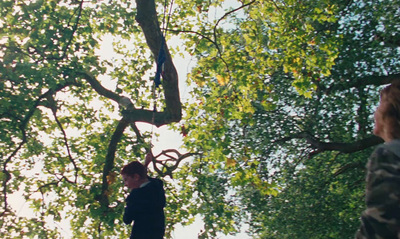 a woman standing in the middle of a forest