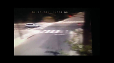 a car driving down a street next to a street sign