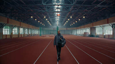 a man walking across a track in a building