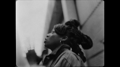 a black and white photo of a woman with braids