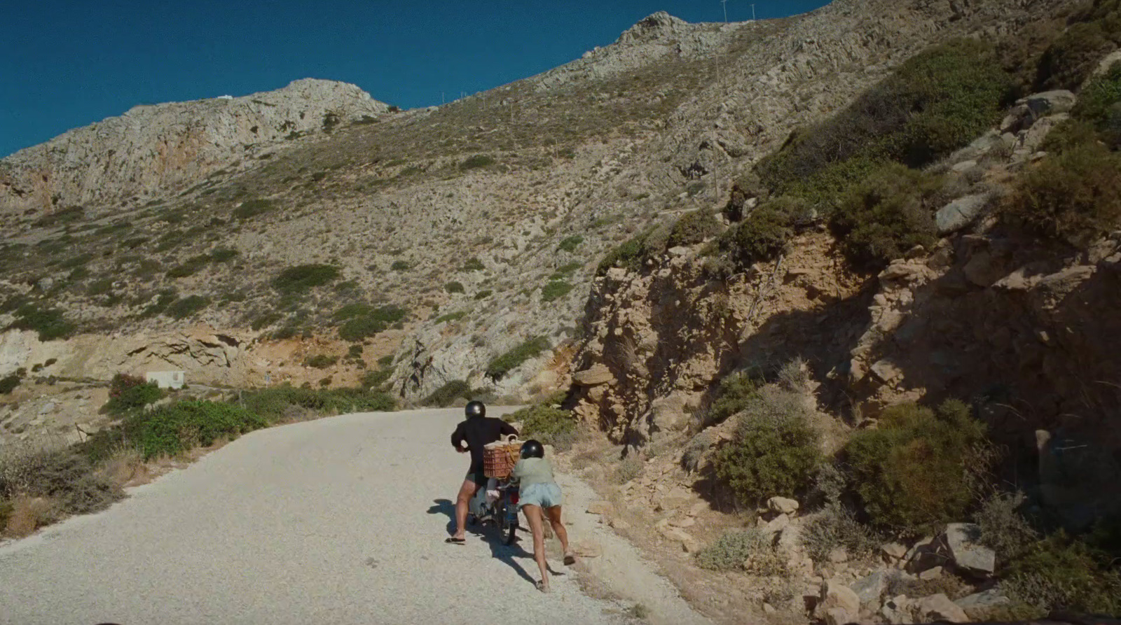 a couple of people that are standing on a road