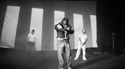 a man standing on a stage with his arms crossed