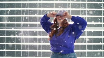 a woman standing in front of a window in the snow