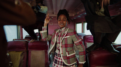 a woman standing on a bus with her hands in the air