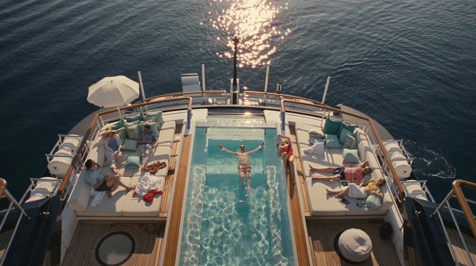 a group of people sitting around a swimming pool on a boat