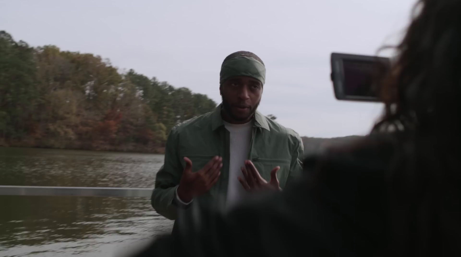 a man standing in front of a body of water