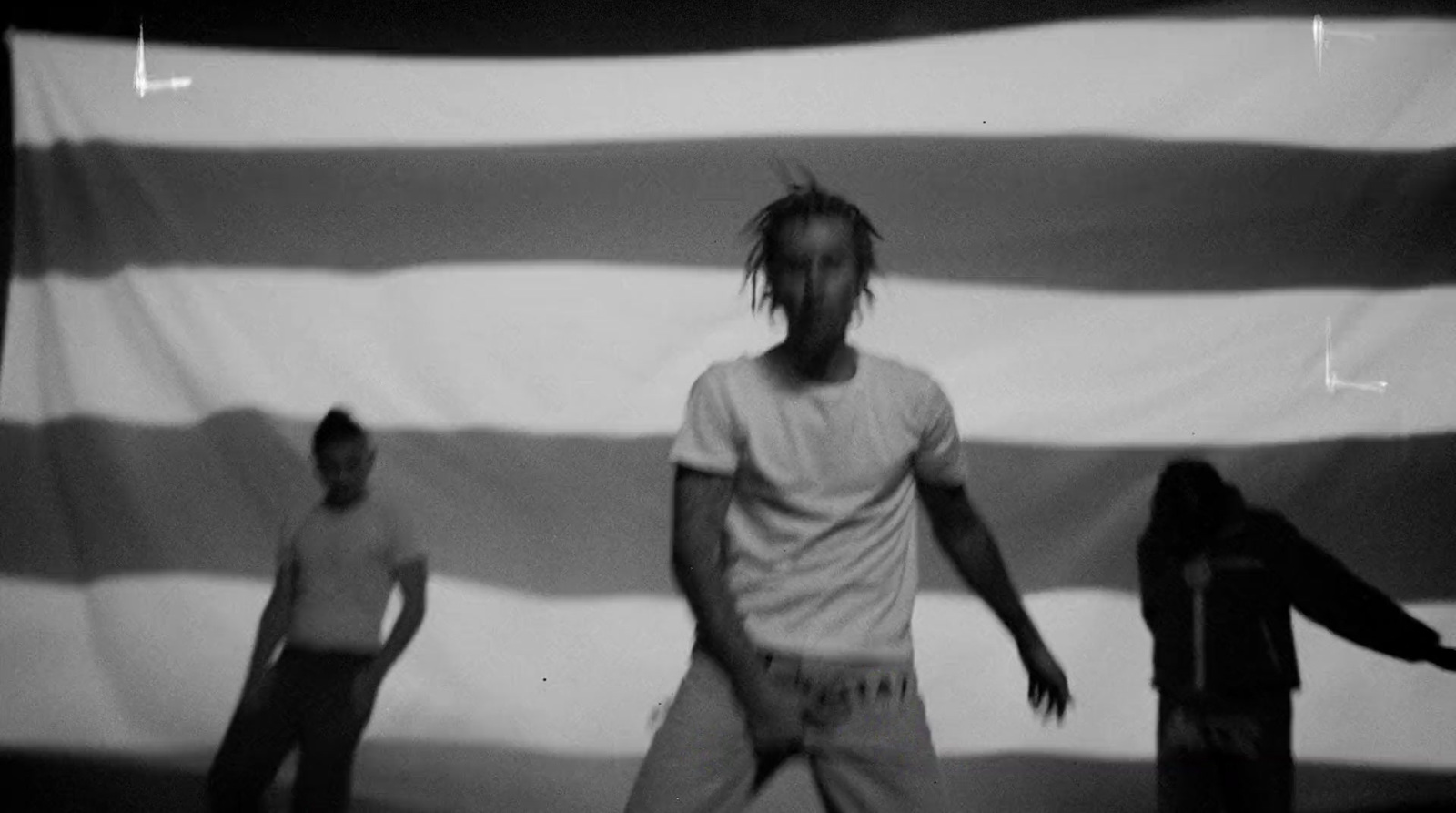 a man standing in front of a large american flag