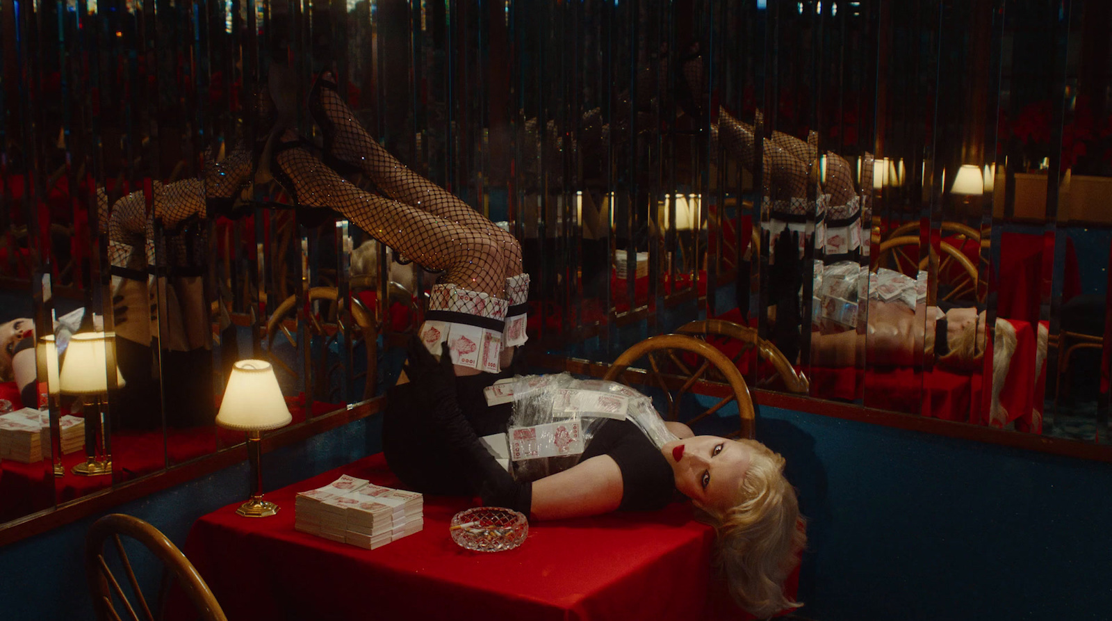 a woman laying on top of a red table