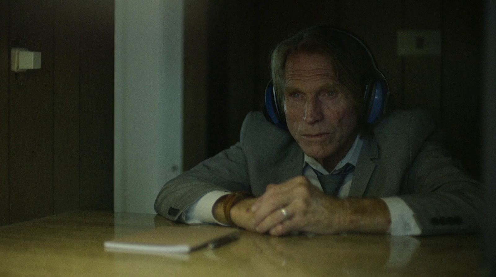 a man wearing headphones sitting at a table