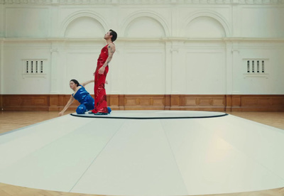 a woman in a red dress standing on top of a white floor