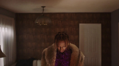 a woman with dreadlocks standing in a room