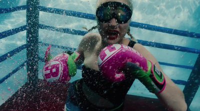 a woman wearing goggles and boxing gloves in the water