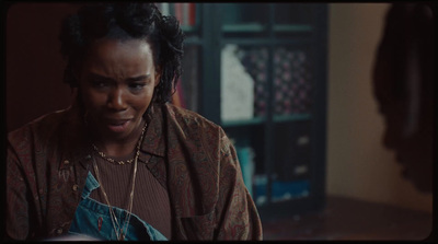 a woman with dreadlocks standing in a room