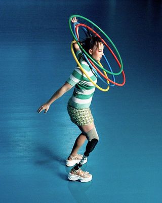 a young girl balancing with a hula hoop