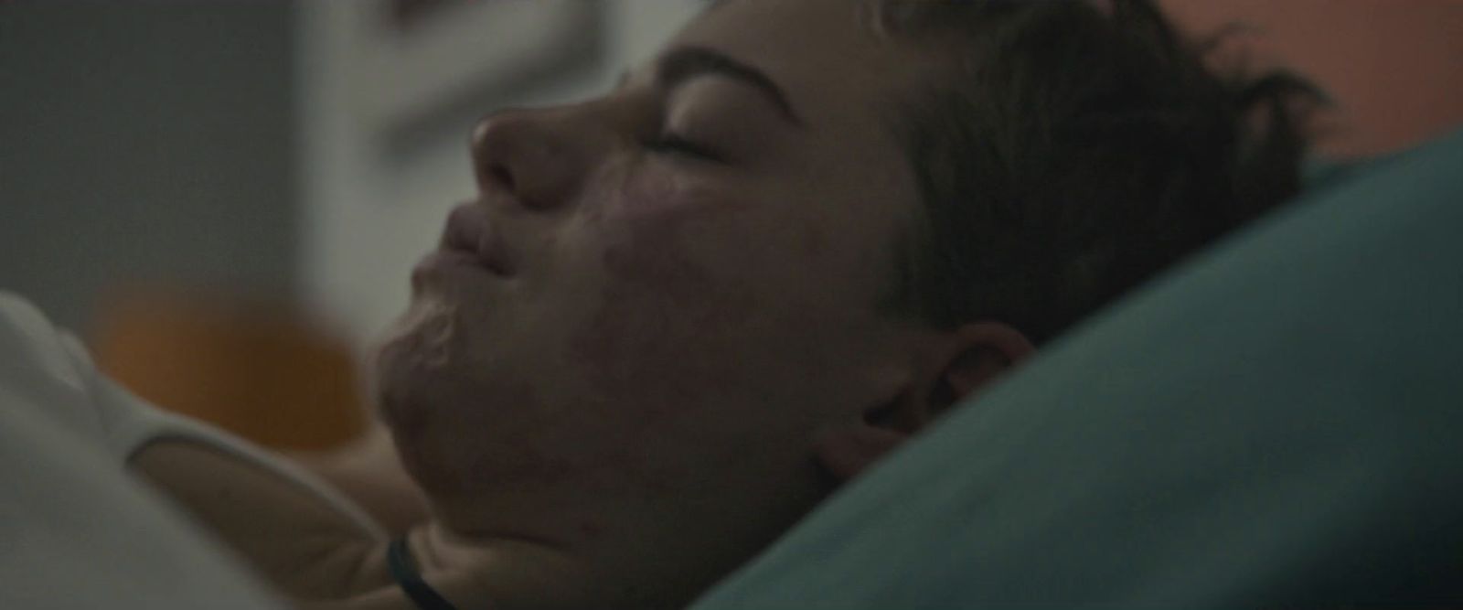 a woman laying in bed with her eyes closed