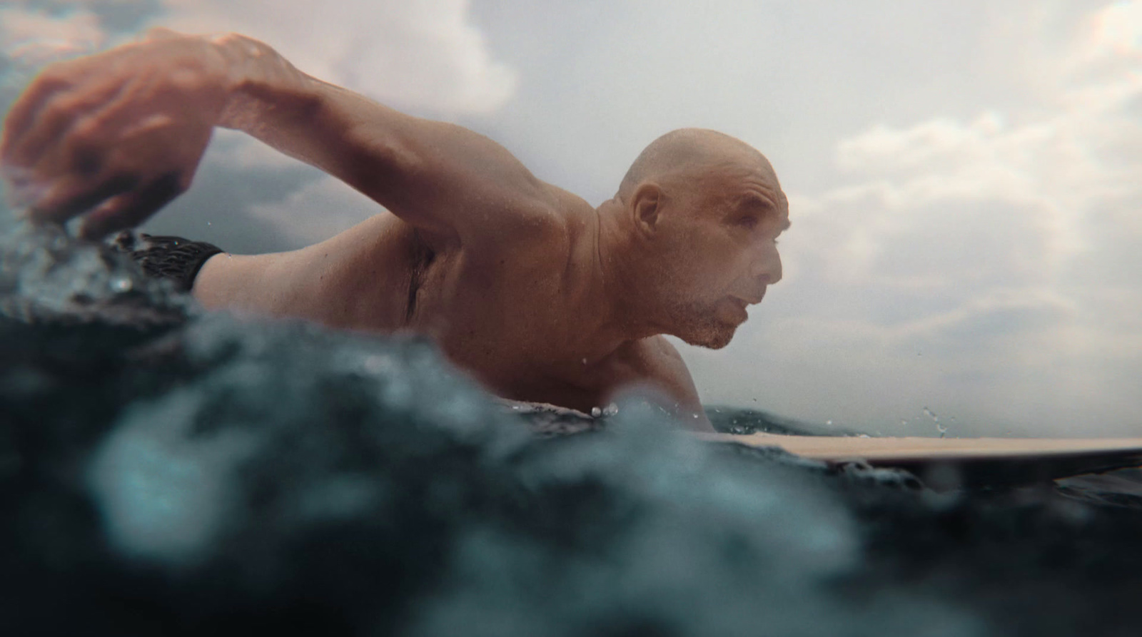 a man riding a wave on top of a surfboard