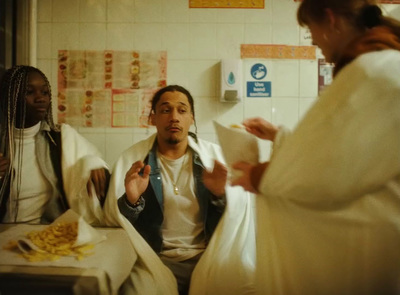 a group of people sitting around a table eating food