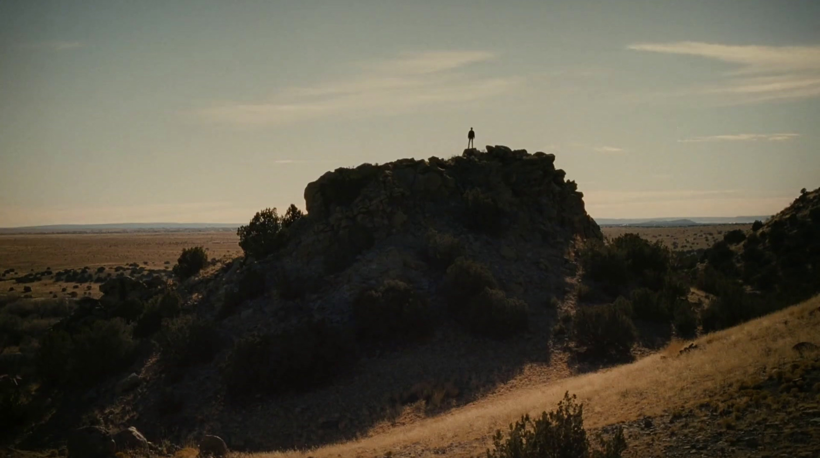 a person standing on top of a large rock