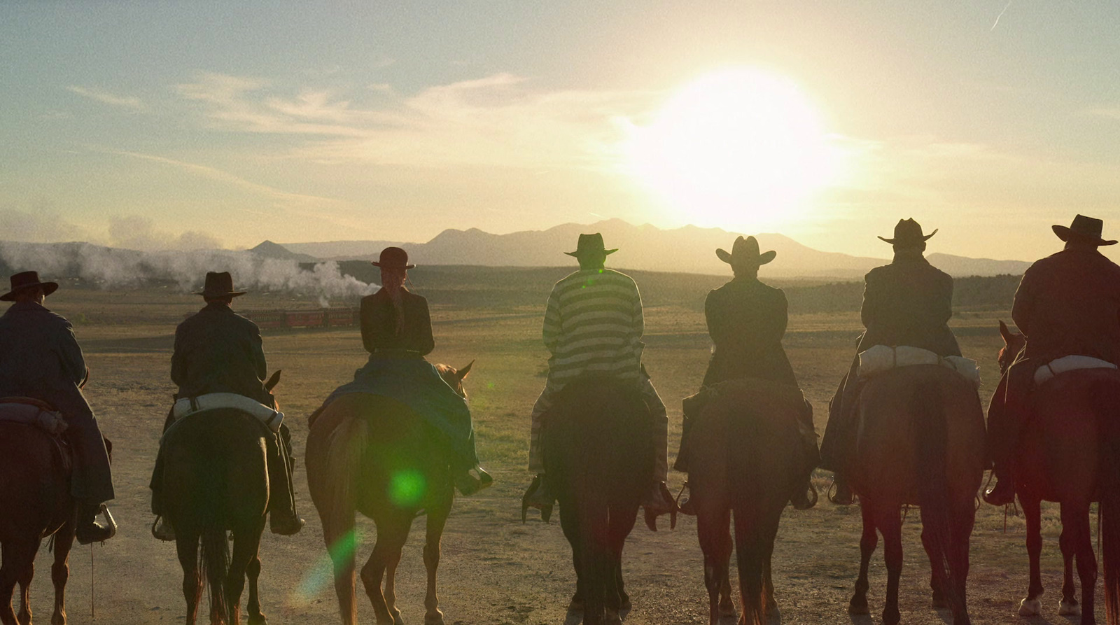 a group of people riding on the backs of horses