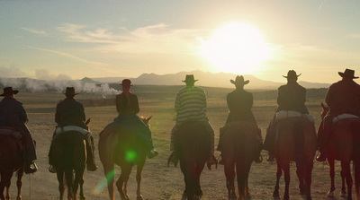 a group of people riding on the backs of horses