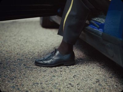 a close up of a person wearing black shoes