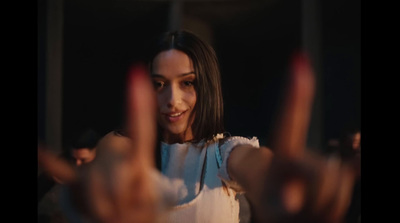 a woman making a peace sign with her hands