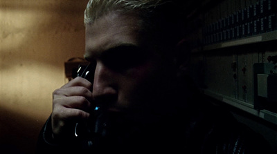 a man talking on a cell phone in a dark room