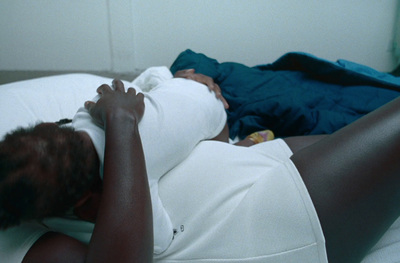 a person laying on a bed with a pillow