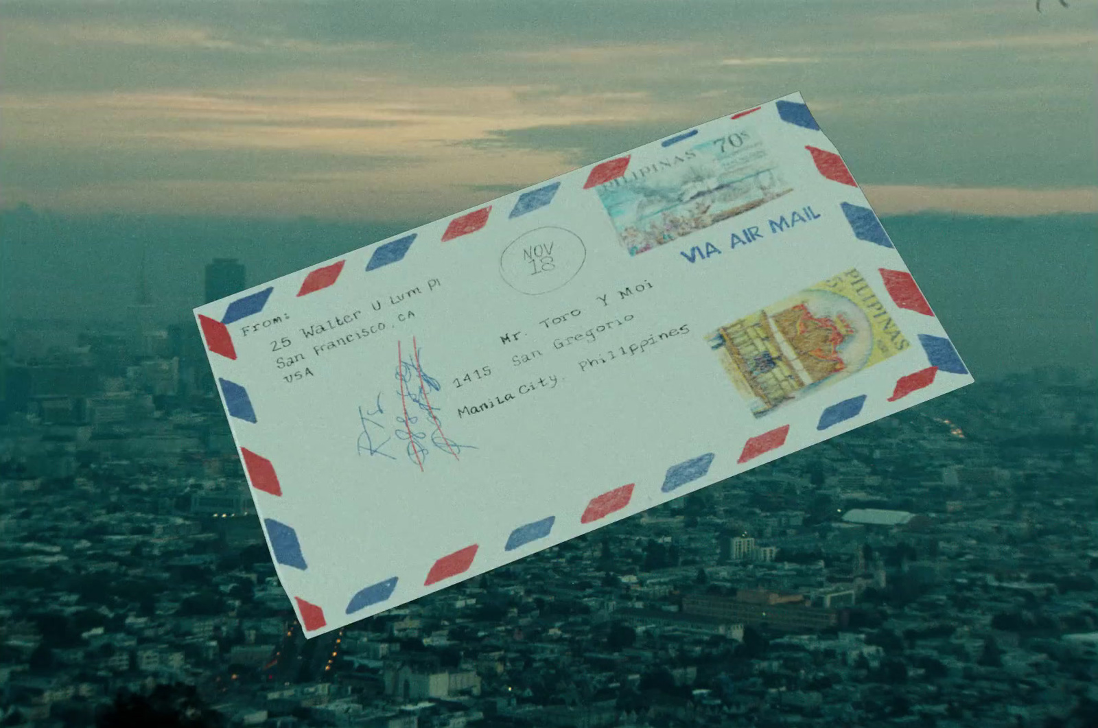 a mail envelope is flying over a city