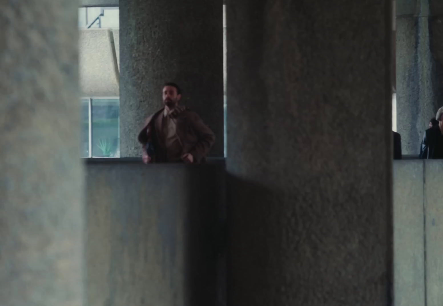 a man sitting on a ledge in a building