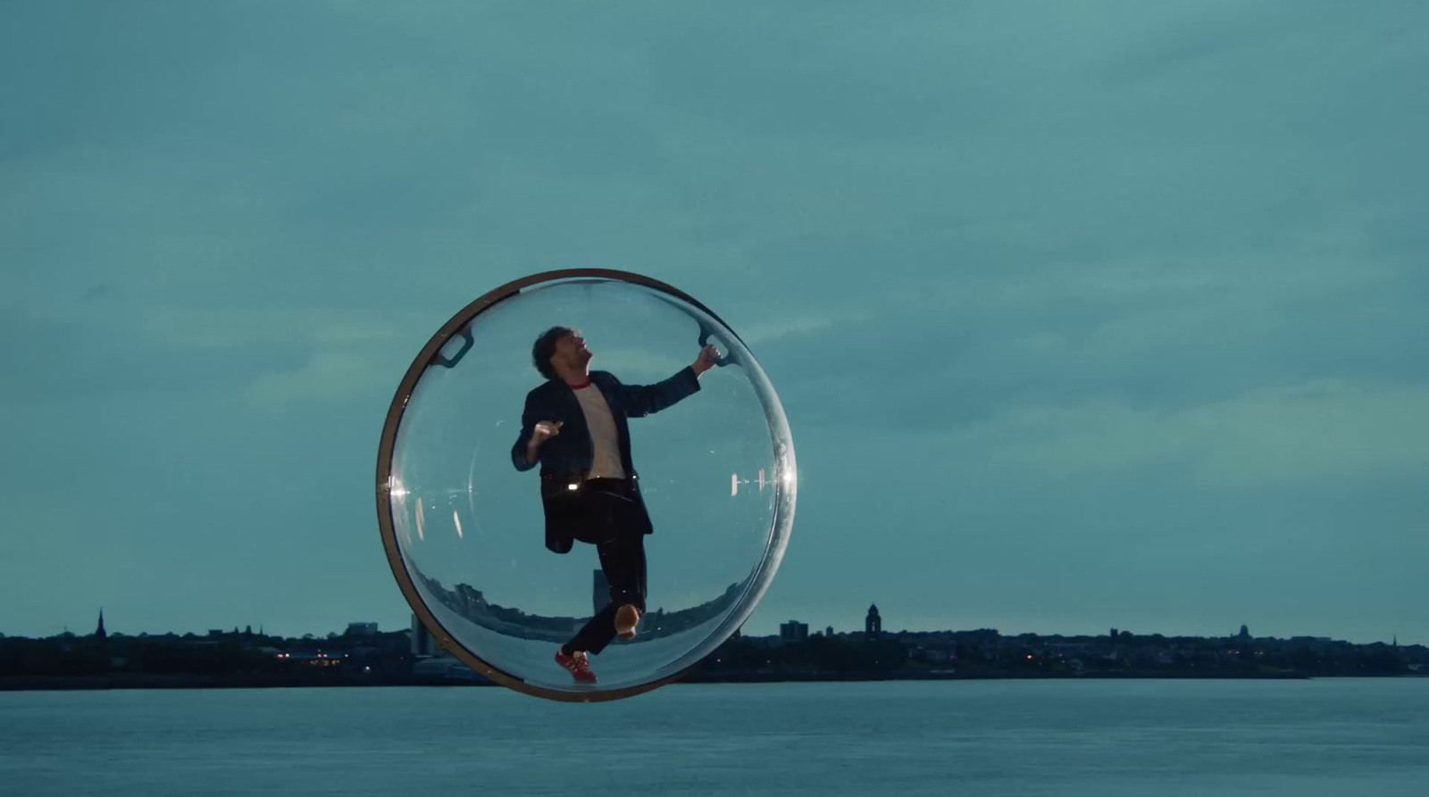 a man standing inside of a glass ball