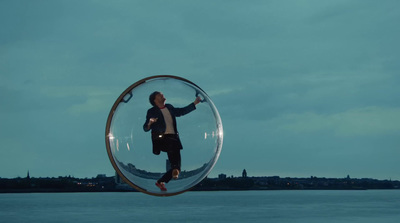 a man standing inside of a glass ball