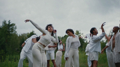 a group of people standing in a field