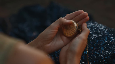 a close up of a person holding a ring