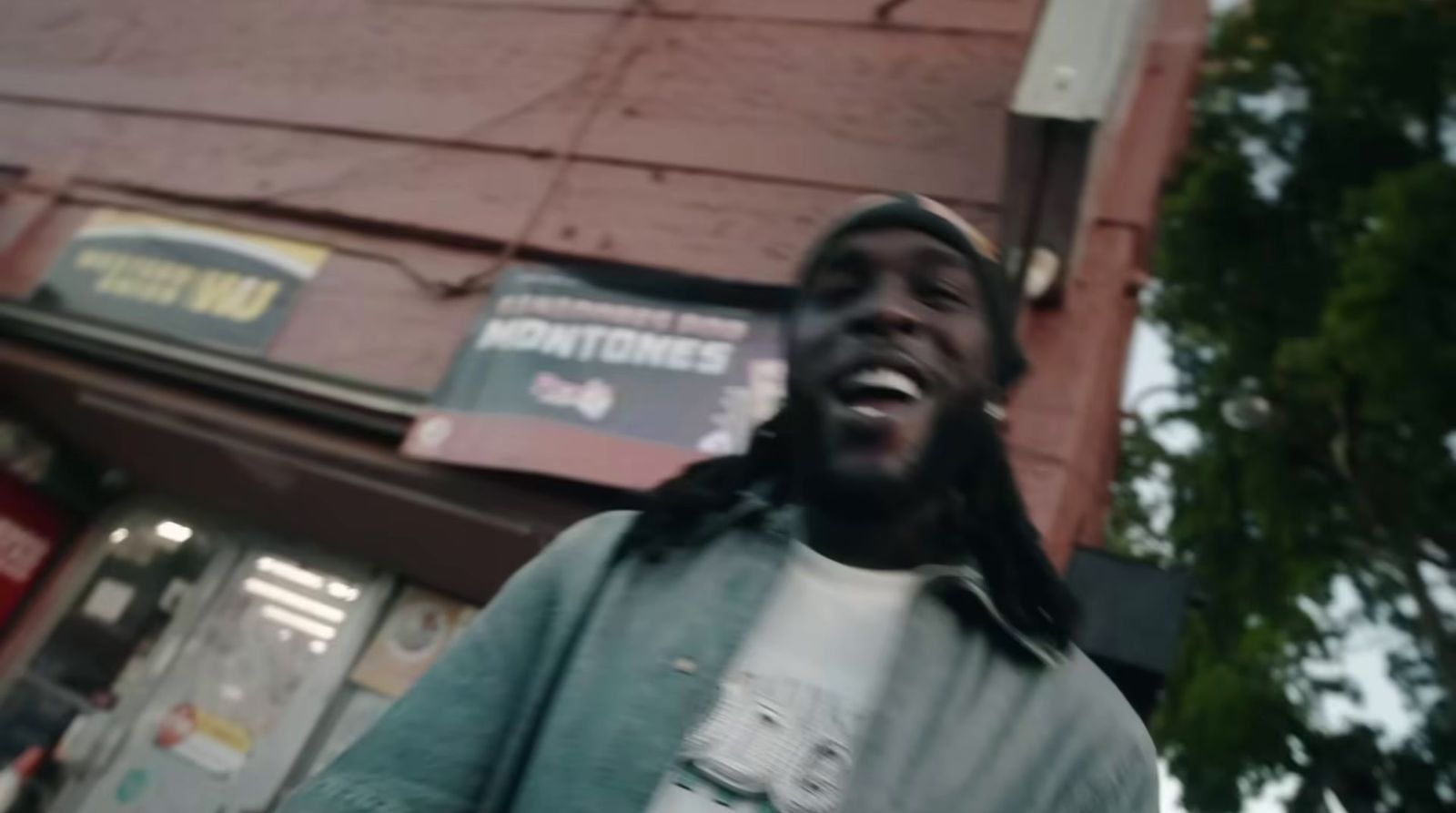 a man standing in front of a building laughing