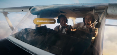 two men sitting in the cockpit of an airplane