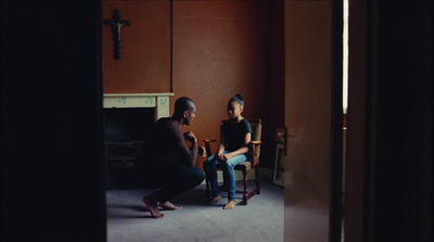 a man and a woman sitting in chairs in a room