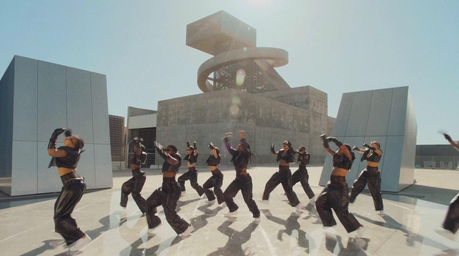 a group of people dancing in front of a building