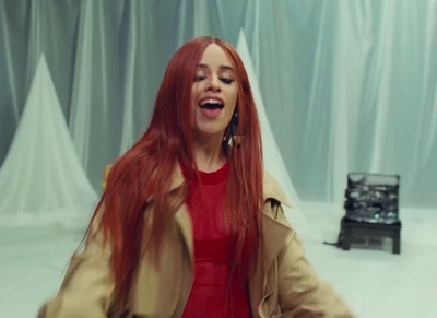 a woman with long red hair and a trench coat