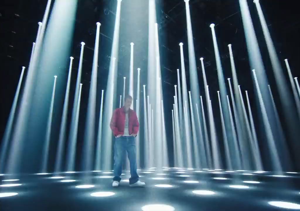 a man standing in a room filled with lots of lights