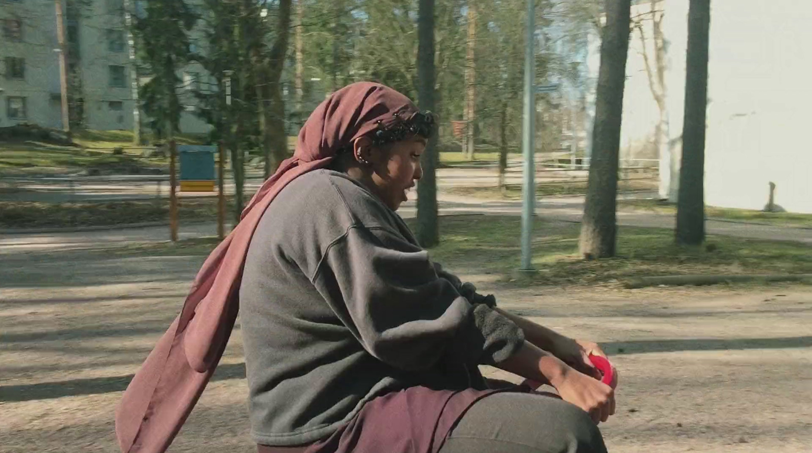 a woman riding a skateboard down a street