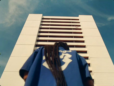 a woman standing in front of a tall building