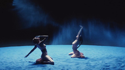 two women in bikinis on a blue surface