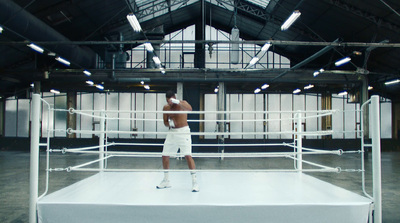 a man standing in front of a boxing ring