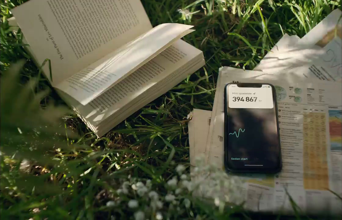 a cell phone sitting on top of a book in the grass