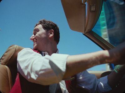 a man sitting in the back seat of a car